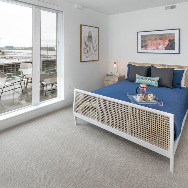 Rivage Apartments - Spacious Bedroom with Carpet flooring and Private Balcony