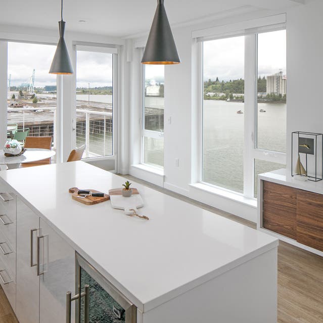Rivage Apartments - Open Concept Kitchen Overlooking Dining Room with Large Island and Views of Willametter River