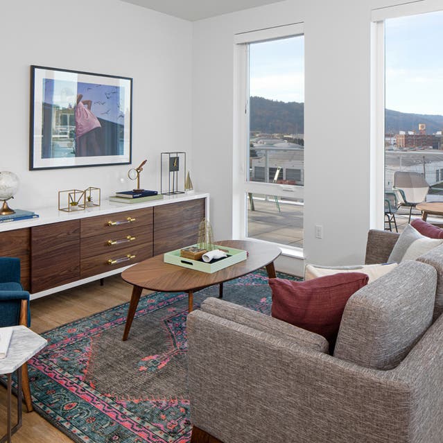 Rivage Apartments - Open Concept Living Room with Hardwood-style Flooring Overlooking Private Balcony