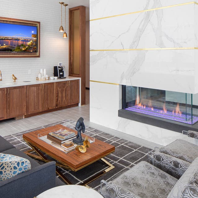 Rivage Apartments - Lobby with Couches, Fireplace, and Coffee Machine