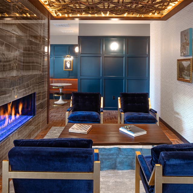 Rivage Apartments - clubroom with comfortable seating and fireplace